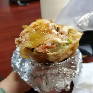Grilled carnitas super burrito with added grilled onions