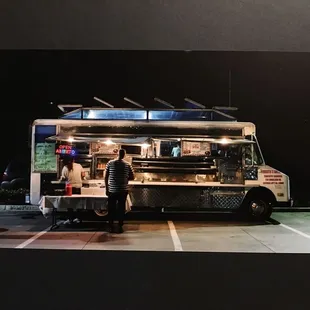 a man standing in front of a food truck