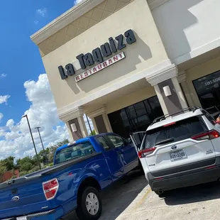 two trucks parked in front of a restaurant