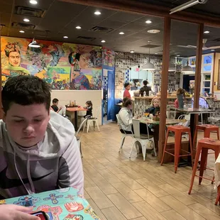  young man sitting at a table in a restaurant