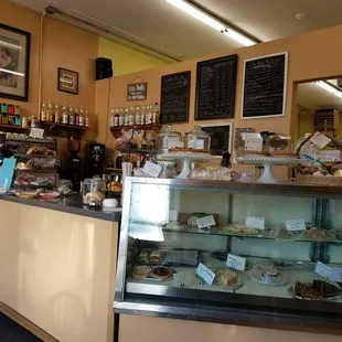 a bakery counter with a variety of baked goods