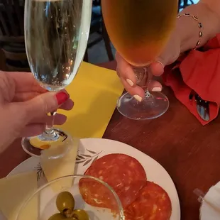 a glass of wine and a plate of olives