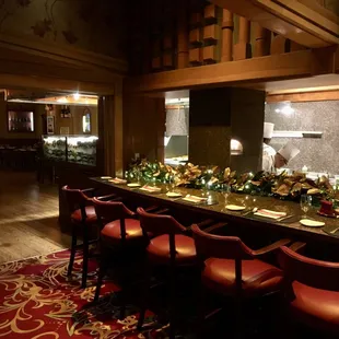 a long bar with red chairs