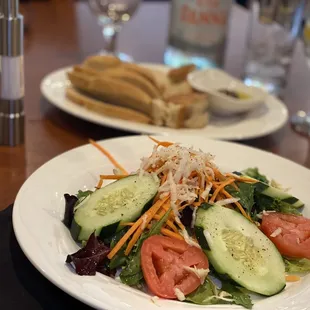 a plate of salad and hotdogs