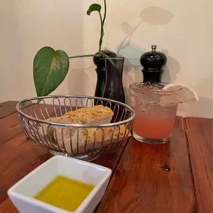 a bowl of bread and a glass of lemonade