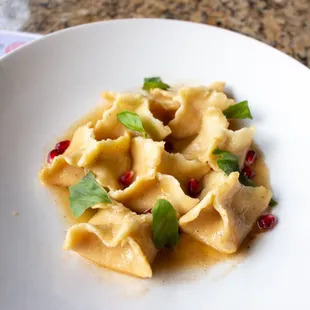 Sweet Potato Ravioli: sweet potato and goat cheese, brown butter, pomegranate