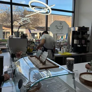 a woman preparing a cup of coffee