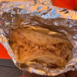 a sandwich wrapped in aluminum foil