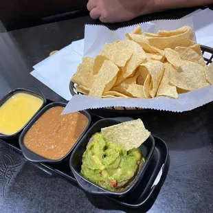 Chips, guacamole, refried beans and queso