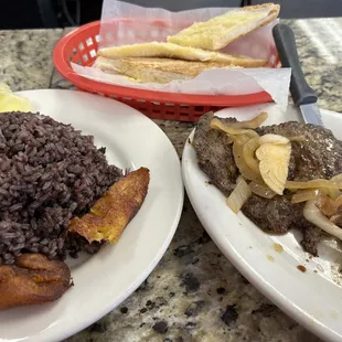 Moro with fried plantains on the side.  Buttered toasted cuban bread.  Palomilla steak.
