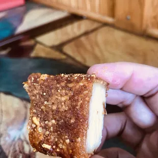 a hand holding a piece of food