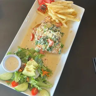 Salmon special w spinach and grape tomato cream sauce,served with truffle fries and house salad.