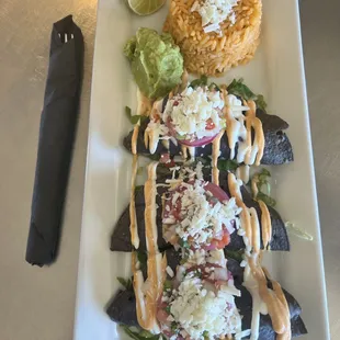 Crispy fish tacos served with rice and side of fresh guacamole