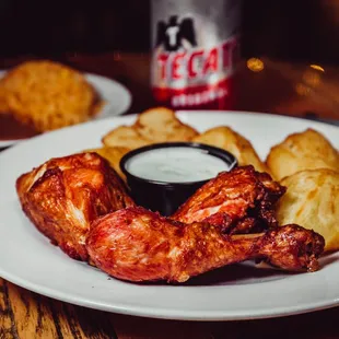 a plate of chicken wings with dipping sauce