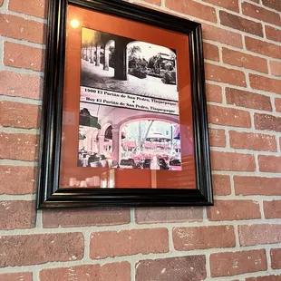 a brick wall with a picture of a restaurant