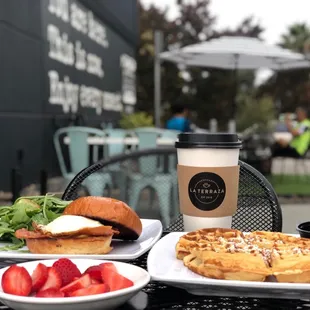 a plate of waffles and a cup of coffee