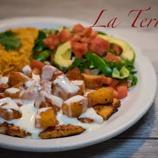 Pollo Hawaiano Grilled chicken breast, topped with pineapple and ham. Served with rice, lettuce, tomatoes, and sour cream.