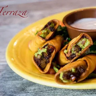 Guaca-rollsFresh guacamole and sun-dried tomatoes in a deep fried wrapped. Served with special spicy sauce