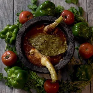 Molcajete 
chicken, steak strips, and shrimp, with onions, mushrooms, and tomatoes. Topped with Nopal, cambray onions, and shredded cheese.