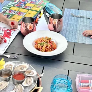 a little boy and girl sitting at a table with plates of food