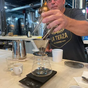 a man pouring coffee
