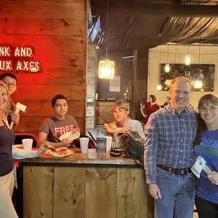 a group of people standing in front of a bar