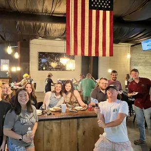 a group of people standing around a bar