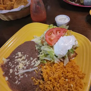 Buried under all that lettuce is a tiny shredded chicken chimichanga.