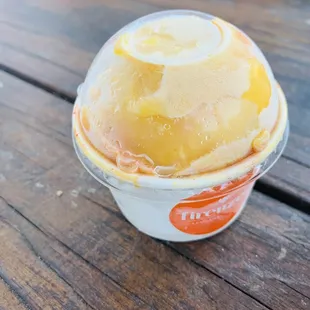 a cup of ice cream on a wooden table