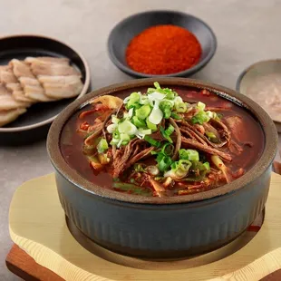 a bowl of soup with meat and vegetables