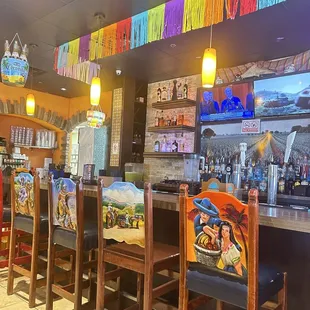 a row of chairs in a mexican restaurant