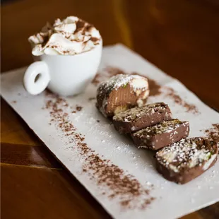SALAME DI CIOCCOLATO is a classic Italian dessert consisting of rich chocolate, cookie crumbs, and a blend of pistachios and hazelnuts.
