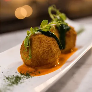 Sicilian Arancini - a delicious preparation balls of risotto breaded and fried , flavored with saffron and stuffed with smoked cheese.