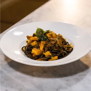 The linguine is infused with squid ink to become our PASTA AL NERO
Squid ink-infused home-made linguine, shrimp, tomato sauce, orange zest,