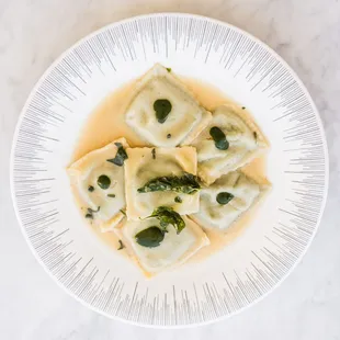 Our home-made ravioli, delicately stuffed w/ Swiss chard, ricotta & Parmesan is topped off w/ sage, brown butter sauce