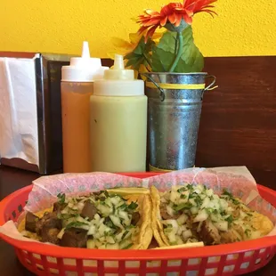 Tacos from back when the dining room was open. Now red and green sauces come in prepacked cups.