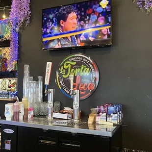 a bar with a television above it