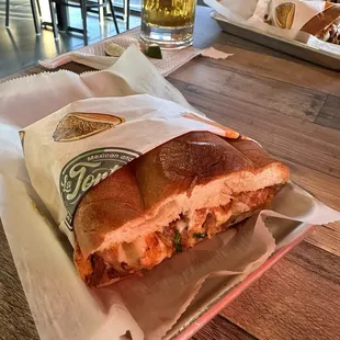 a sandwich and a glass of beer