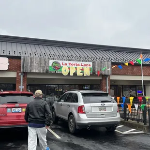 a man walking in front of a store