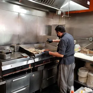 a man preparing food in a commercial kitchen
