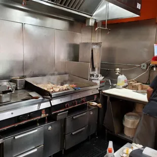 a man cooking in a commercial kitchen
