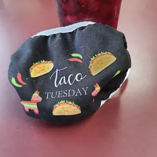 a taco and a drink on a table