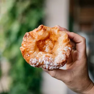 a hand holding a pastry