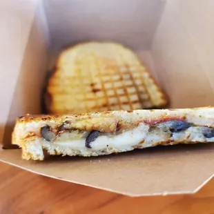 a grilled cheese sandwich in a box