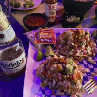 a plate of food and a bottle of beer