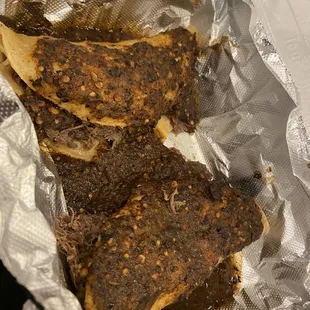 two pieces of meat wrapped in foil