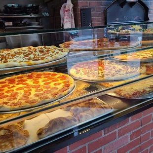 pizzas in a display case