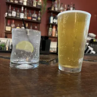 two glasses of beer on a bar
