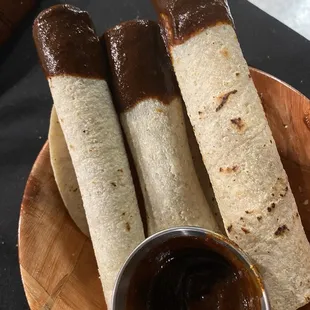 Mexican Cigars dipped in Mole Poblano sauce. Muy bien!  Es la vida Dulce!