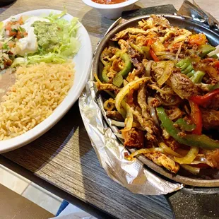 Parrillada: carnitas, shrimp, chorizo, chicken, beef, tomatoes, onions, mushrooms, peppers, rice, beans, guac salad, s. cream, pico de gallo